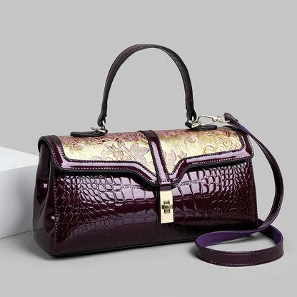 Nouveaux arrivages : Sac à main de luxe pour femmes en cuir verni avec détails floraux.